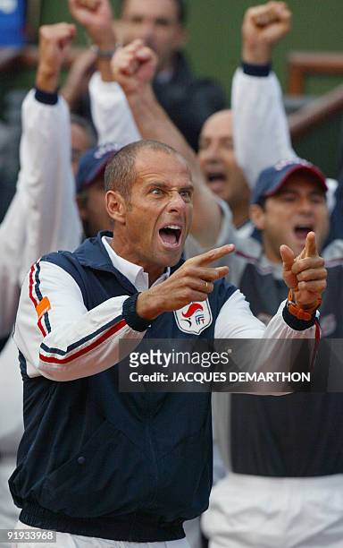 French Davis cup team captain Guy Forget jubilates after France's Arnaud Clément won a point against his US opponent Andy Roddick, 20 september 2002...