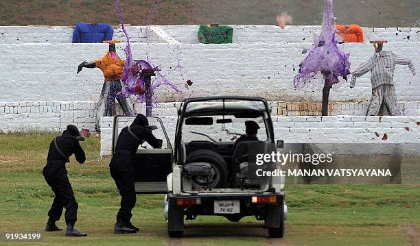 National Security Guards commandos display their counter-terrorism skills during a function to celebrate the 25th NSG Raising day in Gurgaon, around...