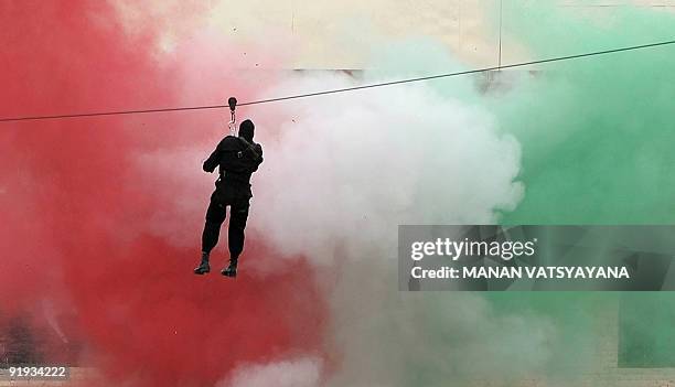 National Security Guards commandos display their counter-terrorism skills during a function to celebrate the 25th NSG Raising day in Gurgaon, around...
