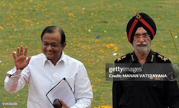 Indian Home Minister P. Chidambaram gestures as National Security Guards Director General N.P.S Aulakh looks on during a function to celebrate the...