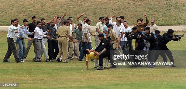 National Security Guards commandos display their skills during a function to celebrate the 25th NSG Raising day in Gurgaon, around 50 kms south of...