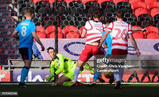 Fleetwood Town's Alex Cairns can't prevent Doncaster Rovers' Tommy Rowe scoring his sides second goal during the Sky Bet League One match between...