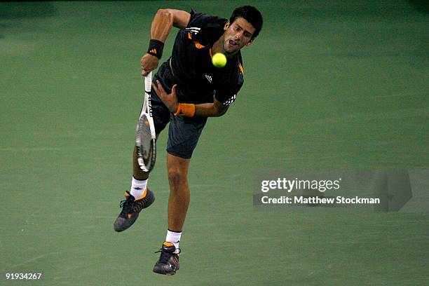 Novak Djokovic of Serbia serves to Gilles Simon of France during day six of the 2009 Shanghai ATP Masters 1000 at Qi Zhong Tennis Centre on October...