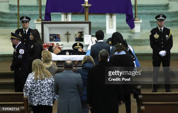 People view the body of slain Chicago police Cmdr. Paul Bauer at Nativity of Our Lord Roman Catholic Church on February 17, 2018 in Chicago,...