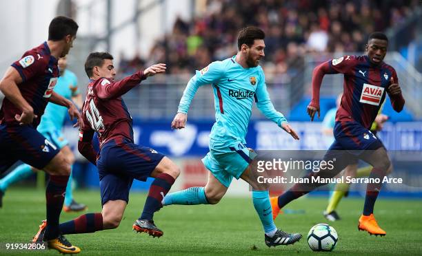 Lionel Messi of FC Barcelona duels for the ball with Daniel Garcia of SD Eibar during the La Liga match between SD Eibar and FC Barcelona at Ipurua...