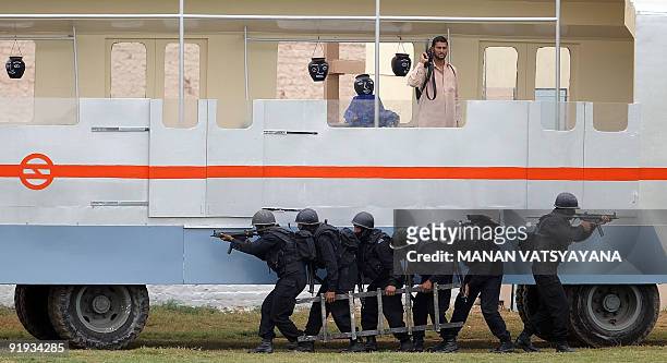 National Security Guards commandos display their skills during a function to celebrate the 25th NSG Raising day in Gurgaon, around 50 kms south of...
