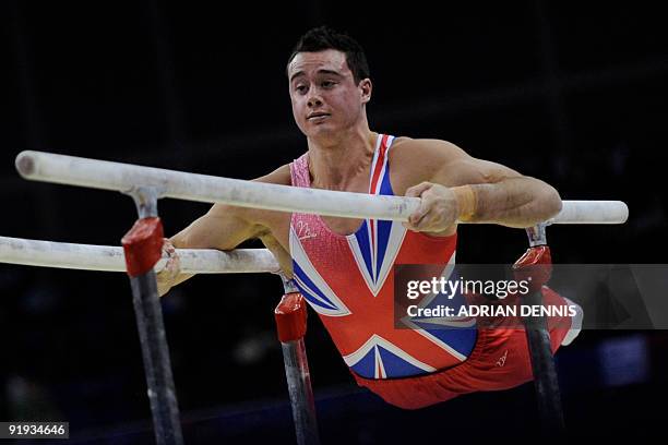 Britain's Kristian Thomas performs in the parallel bars event in the men's individual all-around final during the Artistic Gymnastics World...