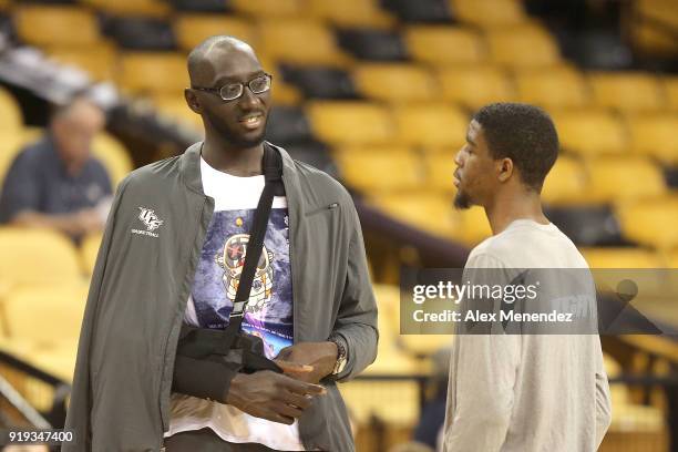 Tacko Fall of the UCF Knights speaks with Collin Smith of the UCF Knights during a NCAA basketball game between the SMU Mustangs and the UCF Knights...