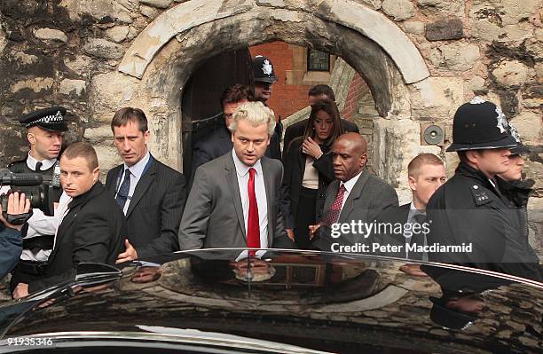 Right-wing Dutch MP Geert Wilders is surrounded by security officials and police as he leaves a press conference for Parliament on October 16, 2009...