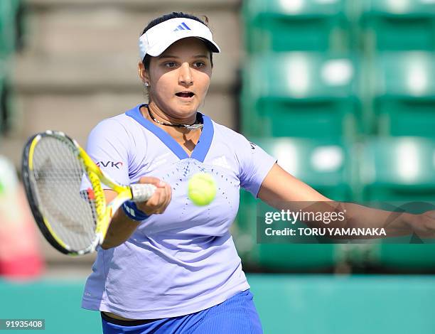 Sania Mirza of Iindia returns the ball against Marion Bartoli of France during the quarter-final match of the Japan Open women's tennis tournament in...