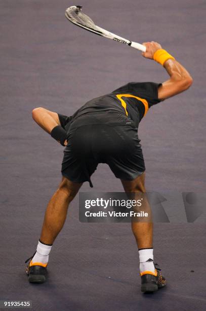 Novak Djokovic of Serbia smashes his racket after loosing a point against Guilles Simon of France during day six of 2009 Shanghai ATP Masters 1000 at...