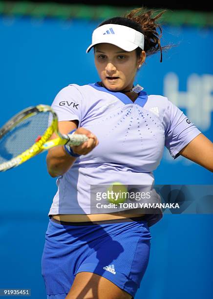 Sania Mirza of Iindia returns the ball against Marion Bartoli of France during the quarter-final match of the Japan Open women's tennis tournament in...