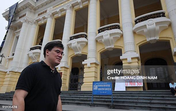 Music Director Alan Gilbert of the New York Philharmonic Orchestra walks in front of the Hanoi Opera House as he leaves after a rehearsal on October...