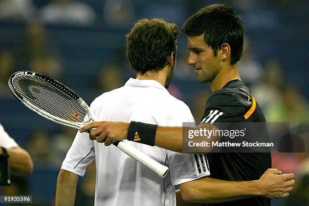 Gilles Simon of France congratulates Novak Djokovic of Serbia after their match during day six of the 2009 Shanghai ATP Masters 1000 at Qi Zhong...