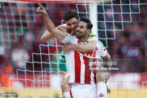 Claudio Pizarro of Koeln celebrates his goal with team mate Jonas Hector before referee Markus Schmidt takes it back because of offside during the...