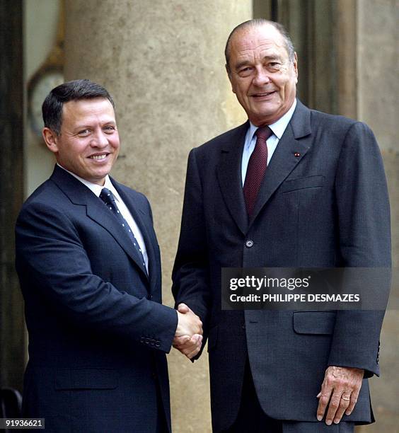 Jordan's King Abdullah II is welcomed by French President Jacques Chirac upon his arrival at the Elysee Palace before talks, 01 October 2003 in...