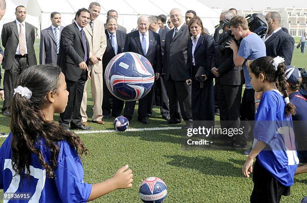 President Joseph S. Blatter watches two young Egyptian girls kick footballs as he inaugurates a new football turf pitch built as part of FIFA's "Win...