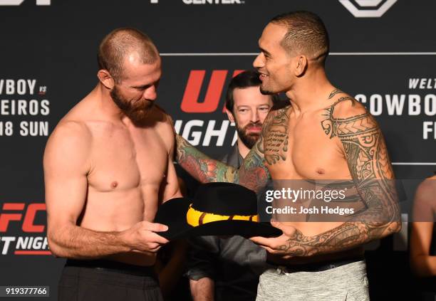 Opponents Donald Cerrone is gifted a cowboy had from opponent Yancy Medeiros face off during the UFC Fight Night Weigh-in at the JW Marriott hotel on...