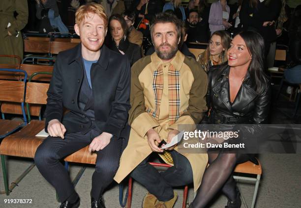 Domhnall Gleeson, Liam Gallagher and Debbie Gwyther wearing Burberry at the Burberry February 2018 show during London Fashion Week at Dimco Buildings...