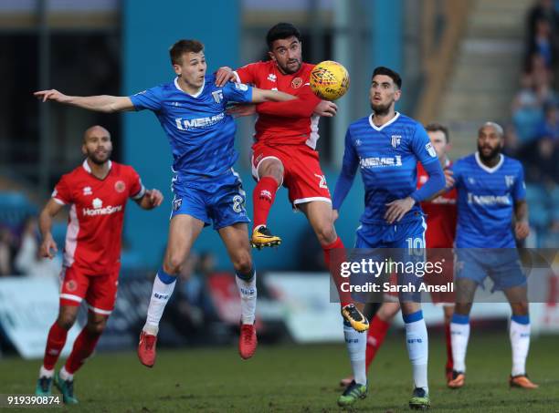 Jake Hessenthaler of Gillingham and Max Kouhyar of Walsall challenge for a goal kick during the Sky Bet League One match between Gillingham and...