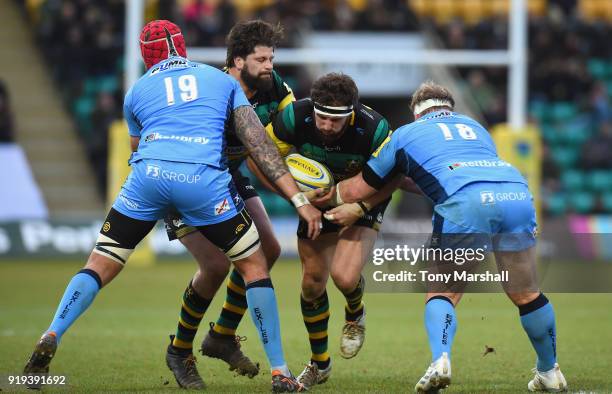 Christian Day of Northampton Saints is tackled by Sebastian De Chaves and Petrus Du Plessis of London Irish during the Aviva Premiership match...