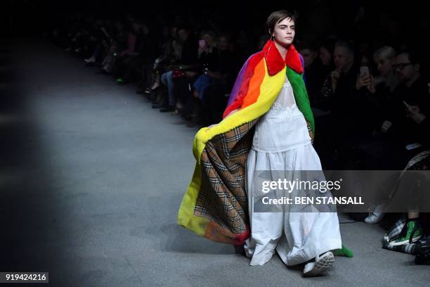 British model Cara Delevingne presents a creation from the Burberry collection during their catwalk show on the second day of London Fashion Week...