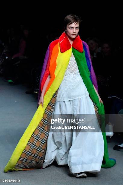 British model Cara Delevingne presents a creation from the Burberry collection during their catwalk show on the second day of London Fashion Week...