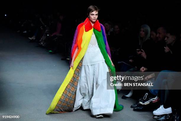 British model Cara Delevingne presents a creation from the Burberry collection during their catwalk show on the second day of London Fashion Week...