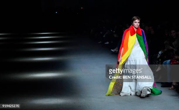 British model Cara Delevingne presents a creation from the Burberry collection during their catwalk show on the second day of London Fashion Week...