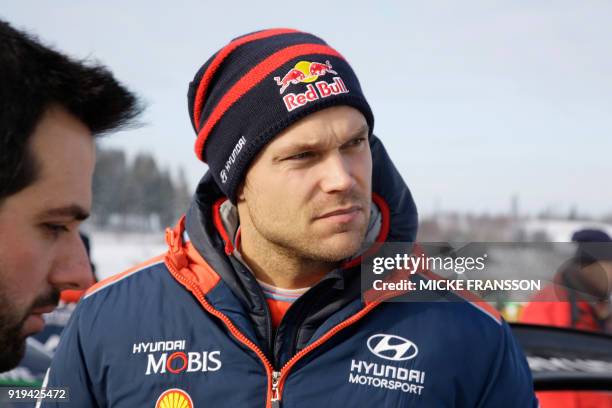 Andreas Mikkelsen of Norway looks on during a stopover during day three of the Rally Sweden 2018 as part of the World Rally Championship in Torsby,...