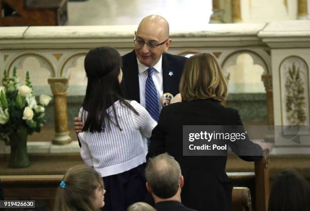 Former Chicago police First Deputy Superintendent John Escalante hugs Grace , daughter of Paul Bauer, and Erin Bauer , wife of Paul Bauer, after...