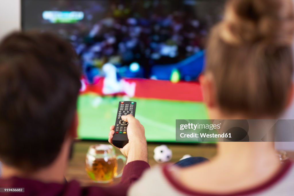 Couple watching football match on Tv