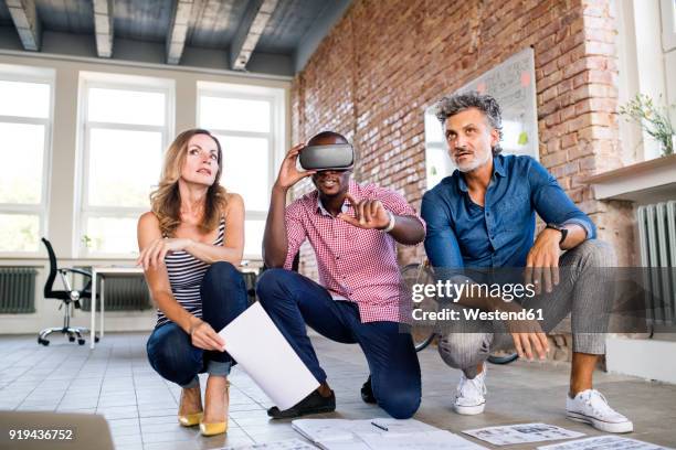 team of architects discussing the rebuilding of a loft office, using 3d goggles - transformation digital stock-fotos und bilder