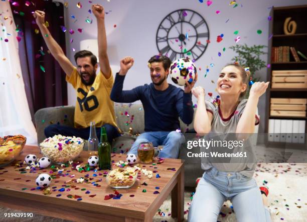 excited fans celebrating at football party - guy looking down stock pictures, royalty-free photos & images