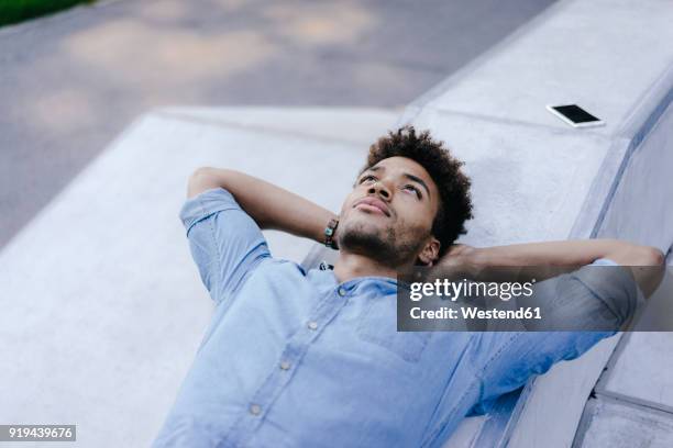 portrait of relaxed man lying in skatepark - man daydreaming stock pictures, royalty-free photos & images