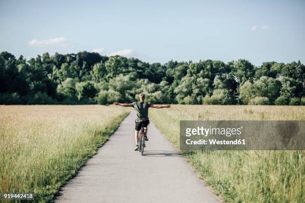 young man riding a bike, freehand - radfahren stock-fotos und bilder