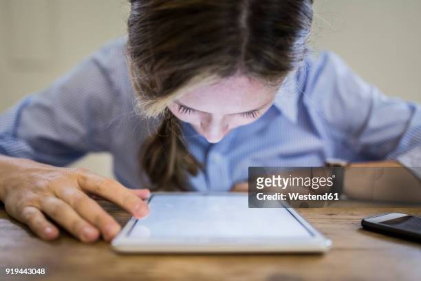 close-up of woman bending over tablet at desk - myopia 個照片及圖片檔