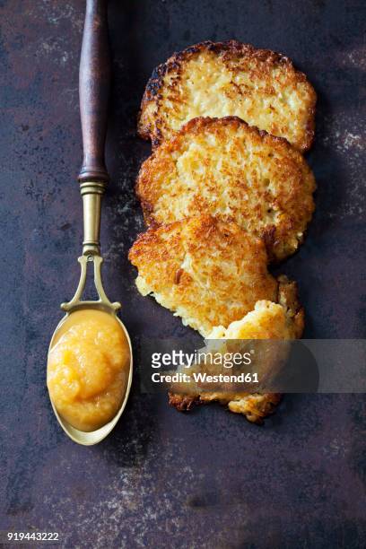 potato fritters and spoon of apple sauce - potato pancake stock pictures, royalty-free photos & images