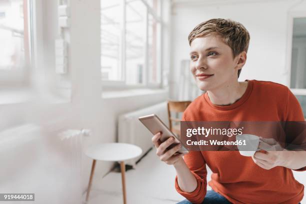 smiling woman with cell phone and espresso cup - espresso drink stock pictures, royalty-free photos & images