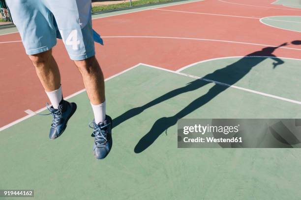 man playing basketball, jumping, shadow - hurling shoes stock pictures, royalty-free photos & images