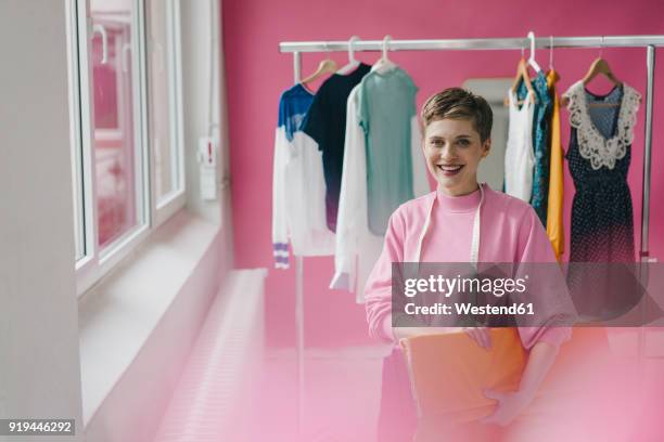 portrait of smiling tailoress - fashion designer stock pictures, royalty-free photos & images
