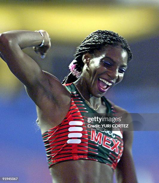 Mexican athlete celebrates after winning the gold medal in San Salvador, El Salvador 05 December 2002. La mexicana Liliana Allen Doll festeja luego...