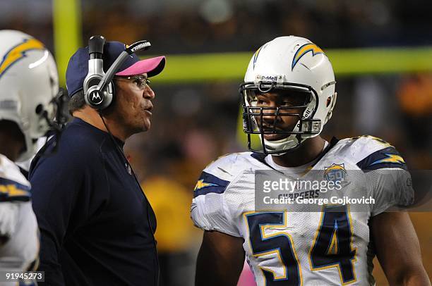 Defensive coordinator Ron Rivera of the San Diego Chargers talks with linebacker Stephen Cooper on the sideline during a game against the Pittsburgh...