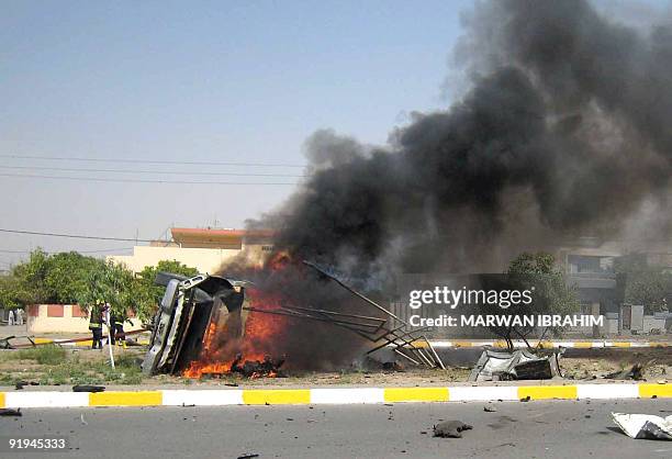 Vehicle burns following a suicide attack in the northern city of Kirkuk, 255kms from Baghdad May 12 2009. A suicide bomber in a pick-up truck...