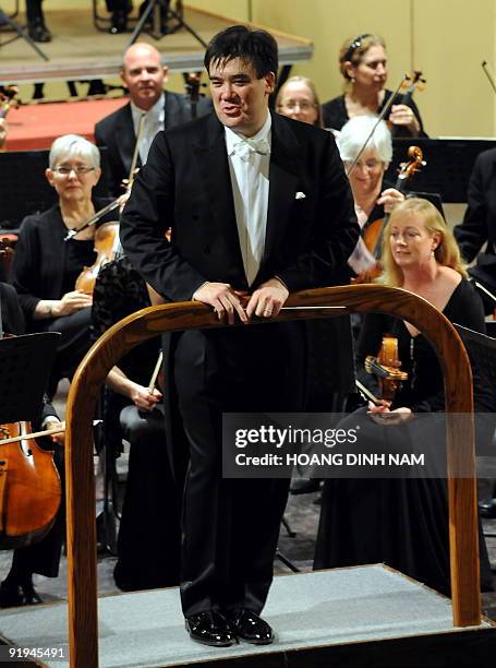 Music director Alan Gilbert of the New York Philharmonic says thanks to spectators who keep applauding at the end of a concert given at the Hanoi...