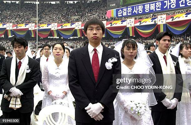 Some 60,000 Unification Church members from all over the world take part in a mass Moonie wedding ceremony at the Chamsil Olympic Stadium in Seoul 13...