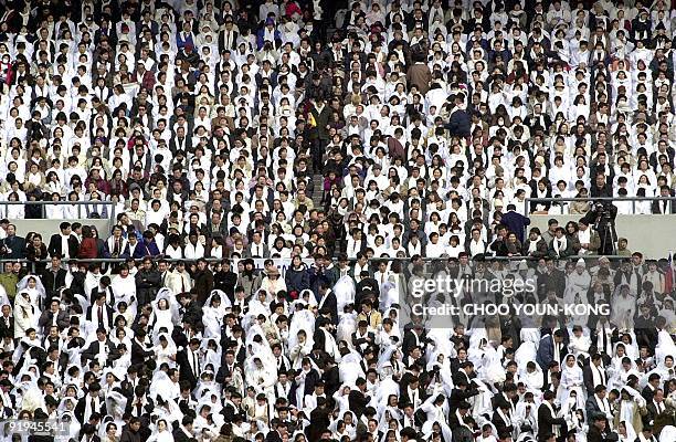 Some 60,000 Unification Church members from all over the world take part in a mass Moonie wedding ceremony at the Chamsil Olympic Stadium in Seoul 13...