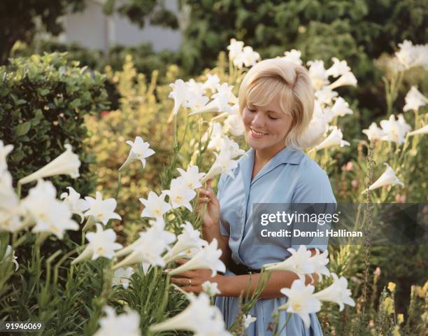 Young woman in Easter Lily garden