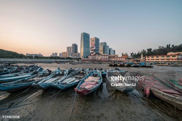 old fishing port and modern city center, xiamen - 福建省 stock pictures, royalty-free photos & images