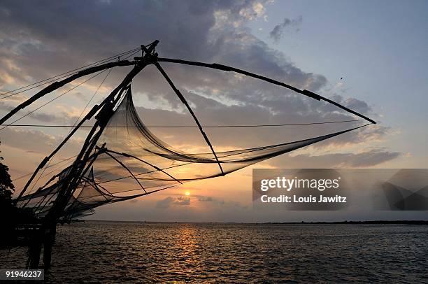 india, kochi ,cochin, chinese fishing nets , cheena vala ,near fort kochi,india,water,sunset,sky,jew town area - cheena vala stock pictures, royalty-free photos & images
